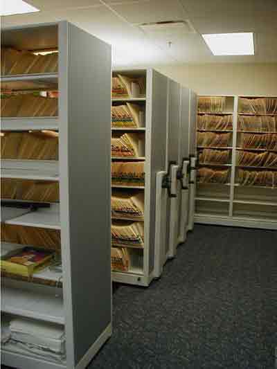Laminate end panels dress up Auora movable shelving! easier to move than rolling down a car window! and many times the file density as compared to lateral  file cabinets. for a free estimate call us today or click below for more information!